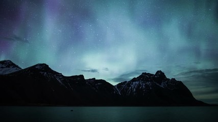 Wall Mural - flashing pulsating aurora borealis vesturhorn mountains stokksnes, iceland 4k