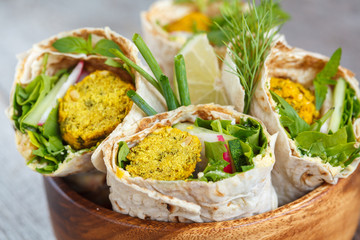 Wall Mural - Vegan falafel wraps with salad and hummus. Love for a healthy vegan food concept.