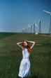 © SHOTPRIME STUDIO - Beautiful young woman in a field near a windmill, summer, sun
