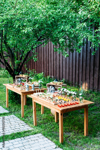 Beautiful Catering Banquet Buffet Table Decorated In Rustic Style In The Garden Different Snacks Sandwiches And Cocktails Outdoor Two Tables With Snacks Under The Tree Vertical Photo Stock Photo Adobe Stock