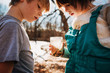 © RooM The Agency - Boy and girl holding a jar with water bugs