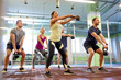 © Syda Productions - group of people with kettlebells exercising in gym