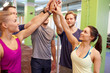 © Syda Productions - group of happy friends making high five in gym
