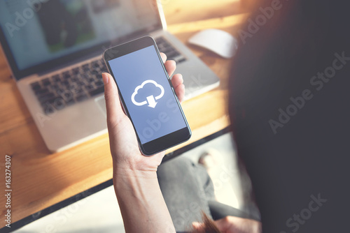Fotografía Closeup hand of woman with Cloud download on mobile smartphone.