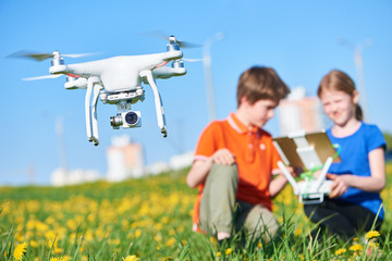 Wall Mural - children operating of flying drone at sunset