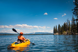 Fototapeta Góry - Woman kayaking on Lake Jenny in Grand Tetons National Park
