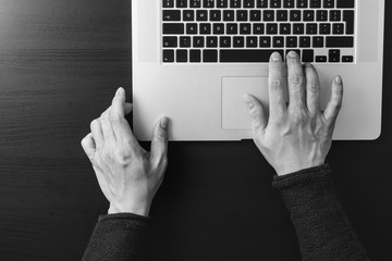 Poster - cyber security internet and networking concept.Businessman hand working with laptop computer,black and white