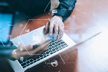 Poster - cyber security internet and networking concept.Businessman hand working with VR screen padlock icon and mobile phone and laptop computer