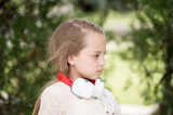 Fototapeta  - pretty little girl enjoying music using headphones