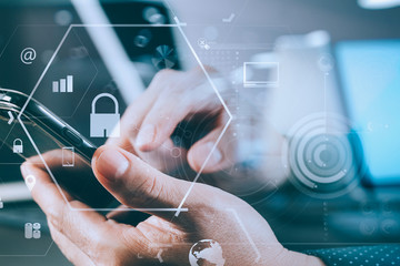 Poster - close up of businessman hand working with smart phone and laptop and digital tablet computer in modern office
