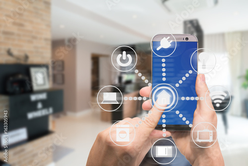 Fotografía Smart home automation app on mobile with home interior in background