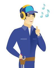 Sticker - Asian mechanic listening to music in headphones.