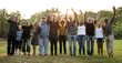© Rawpixel.com - Group of people holding arms raised in the park