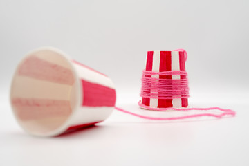 Red striped simple string phone made with white paper cups.