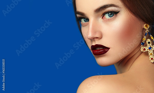 Portrait Of A Beautiful Young Girl On A Blue Background