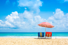 Beach Chairs With Umbrella And Sand Beach In Summer.
