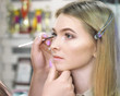 © Sergii Mironenko - Make-up artist makes make-up at the female models face  bright close up