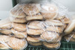 © pavelgulea - Raw frozen buns for burgers of white dough packed in transparent plastic bags.