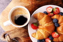 Delicious Breakfast With Fresh Croissants And Ripe Berries On Old Marble Background