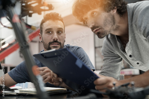 Fotografie, Obraz Engineer and technician working together on drone in office