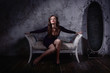 © Demian - Retro styled fashion portrait of a woman in a dark interior