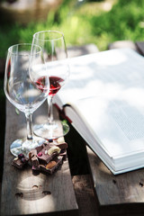 Wall Mural - Glasses with red and white wine, pieces of chocolate, book