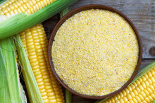 Organic Maize Flour In Wooden Bowl With Fresh Corn. Top View 