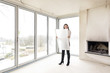 © Westend61 - Woman in empty apartment with plan
