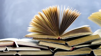 Poster - Books on an old wooden table. Beautiful dark background.