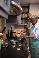 Wall Mural - Man and woman preparing food at home