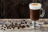 Irish coffee in glass on wooden table