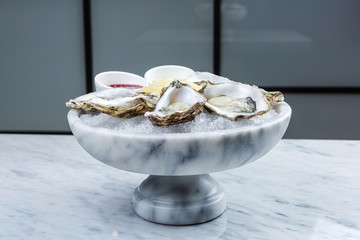 Wall Mural - Fresh oysters platter with sauce and lemon