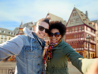 Wall Mural - happy couple taking selfie in frankfurt city