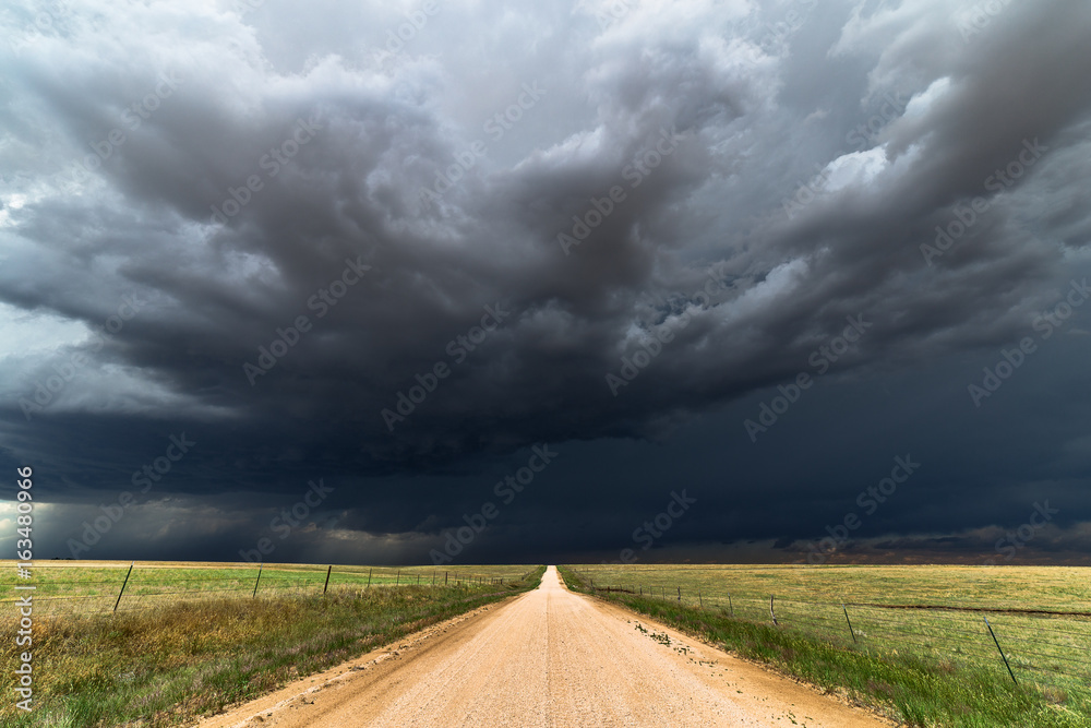 Dirt road with dark storm clouds - obrazy, fototapety, plakaty 