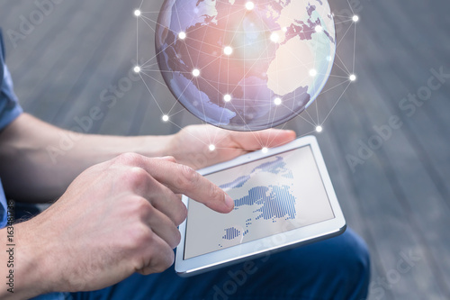 Fotomural World wide business concept, person using AR tablet, 3D globe