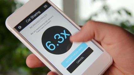 Man requests car and accepts high rates using car sharing application on smartphone