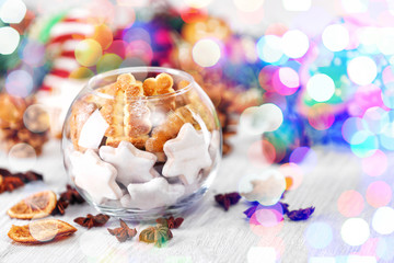 Wall Mural - Glass vase with tasty Christmas cookies on wooden table, close up view