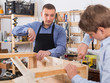 © JackF - father and son repairing wood bench at garage