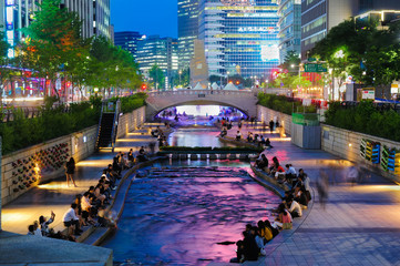 Colorful city lights of Cheonggyecheon Stream Park with Crowd at night in Seoul City, South Korea. 