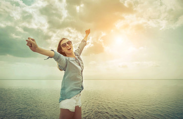 Happy woman relaxation on the sunny sea beach under sunlight sky