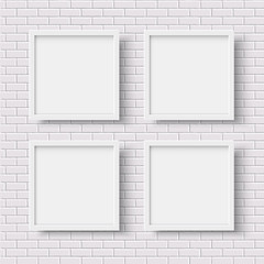 Wall Mural - four white square empty frames on white brick wall