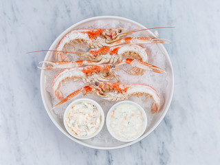 Wall Mural - Fresh lobster with sauce on plate with ice