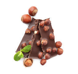 Canvas Print - Broken chocolate pieces with nuts and mint leaves, isolated on white