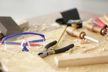 Wall Mural - Table with tools in carpenter's workshop, closeup