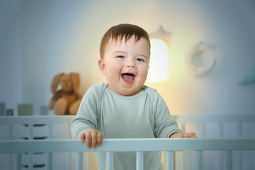 Sticker - Cute little baby standing in crib at home