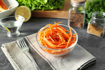 Wall Mural - Delicious carrot salad in bowl on kitchen table