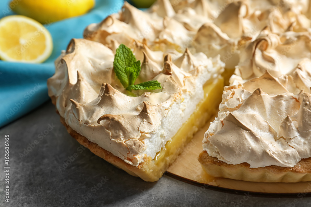 Delicious lemon meringue pie on table