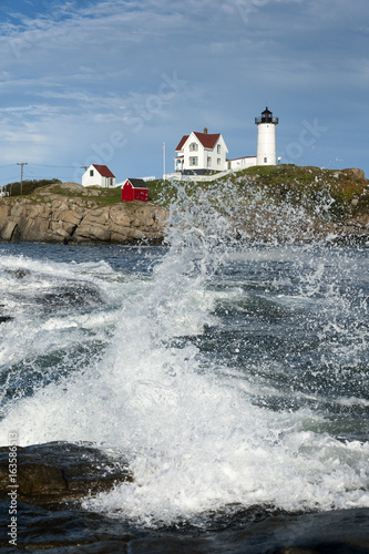Fotografie, Obraz Crashing waves at historic Nubble lighthouse in Maine.