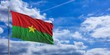 Burkina Faso flag on a blue sky background. 3d illustration