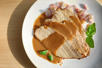Wall Mural - Plate with delicious sliced turkey and sauce on light table
